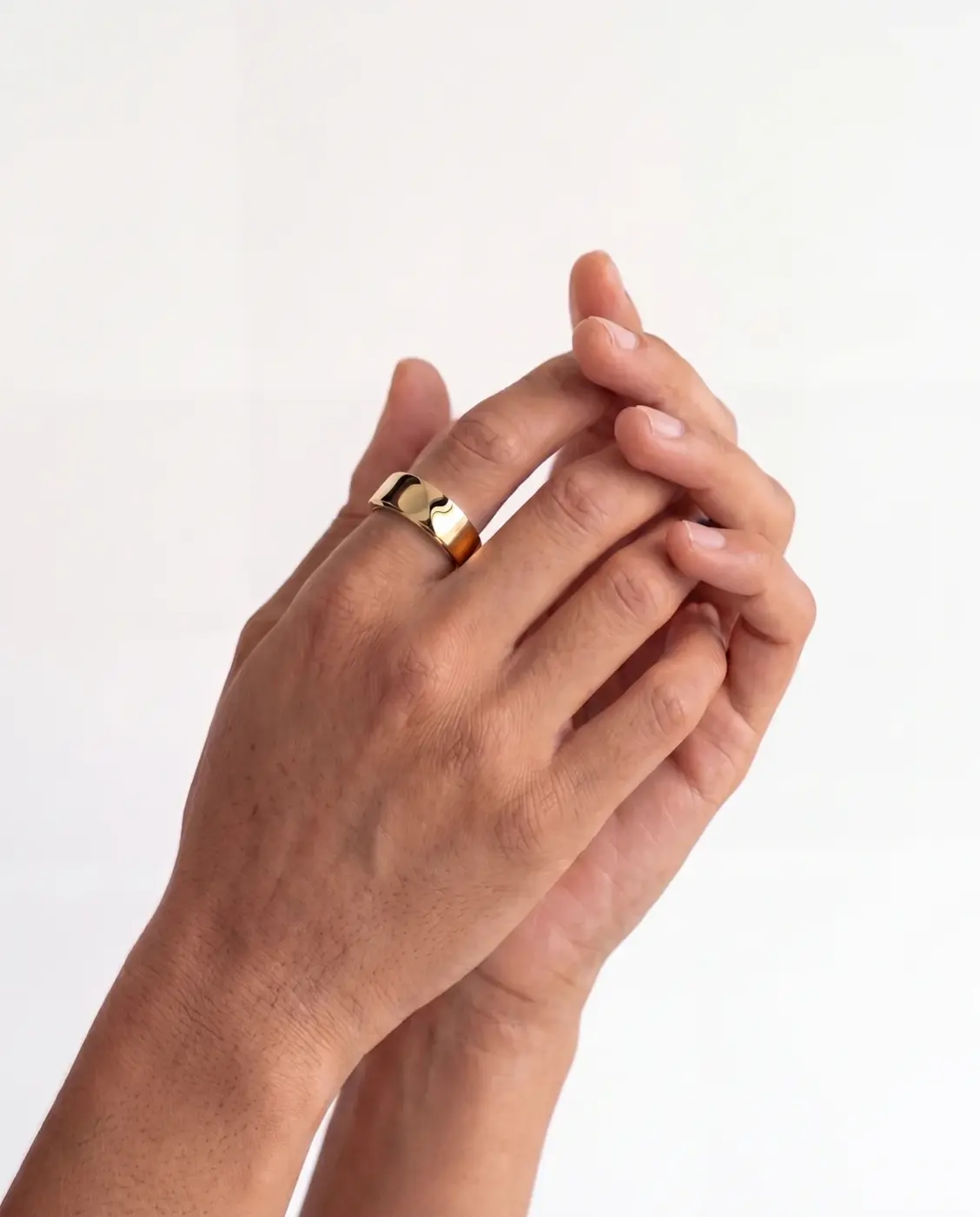 Person wearing a gold smart ring