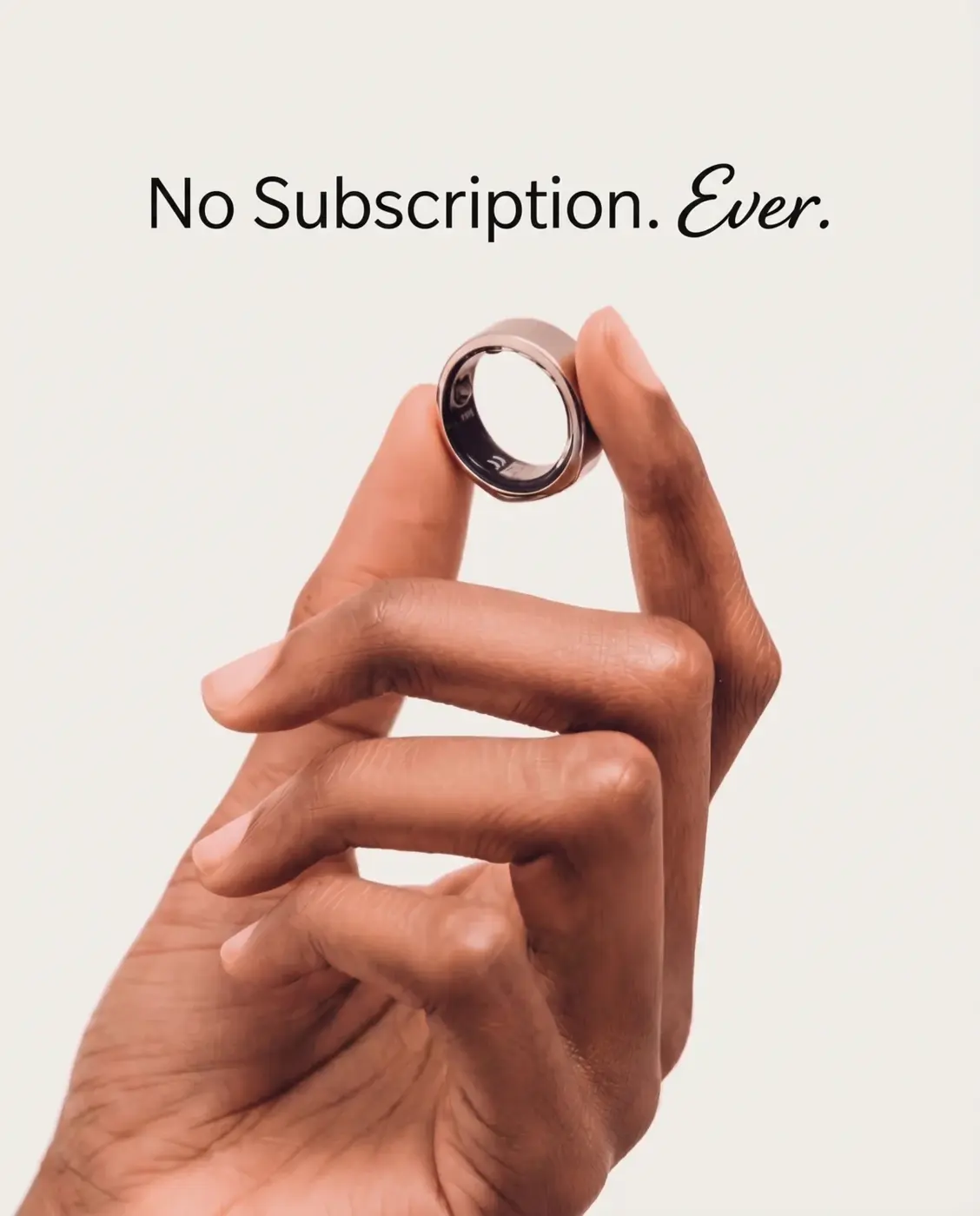 A smart ring held between two fingers with the words No Subscription. Ever.