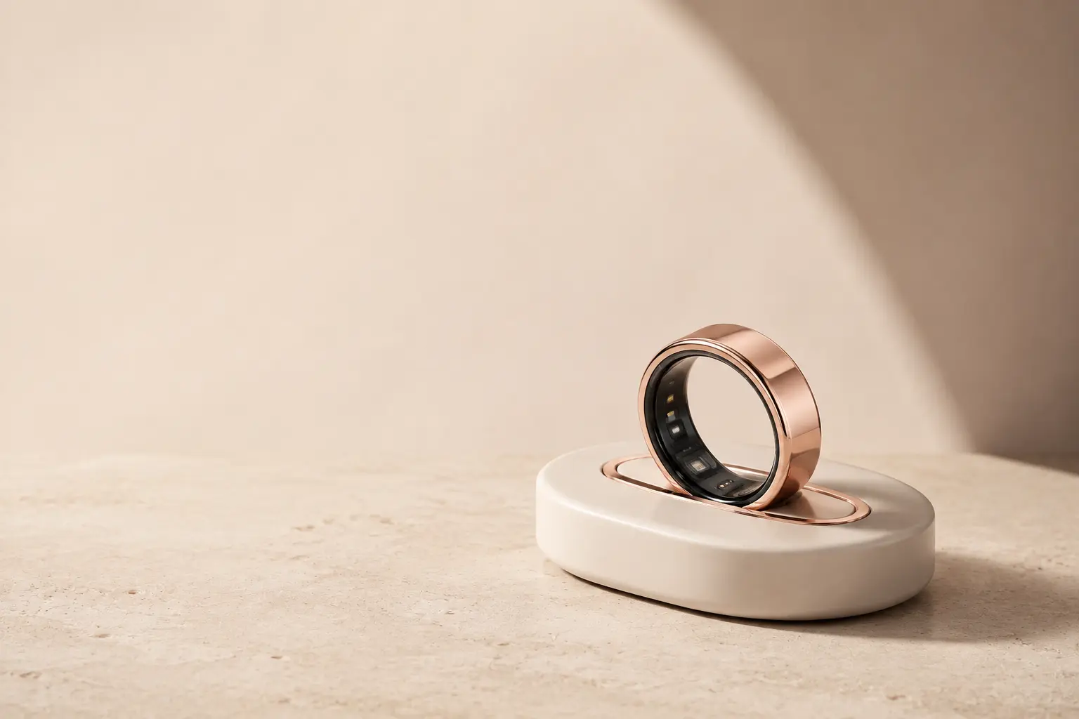 Rose-gold QÛntm smart ring resting upright on its sculpted charging dock